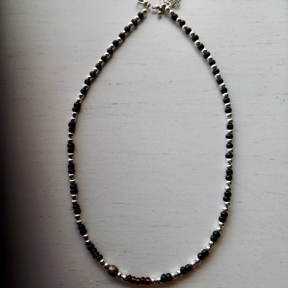 Handmade Black and Silver Beaded necklace. Balanced, minimalist aesthetic.